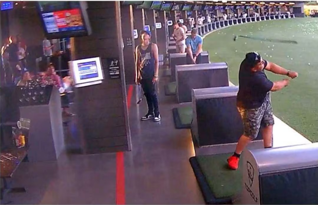 Golfers in the hitting bays at a Topgolf