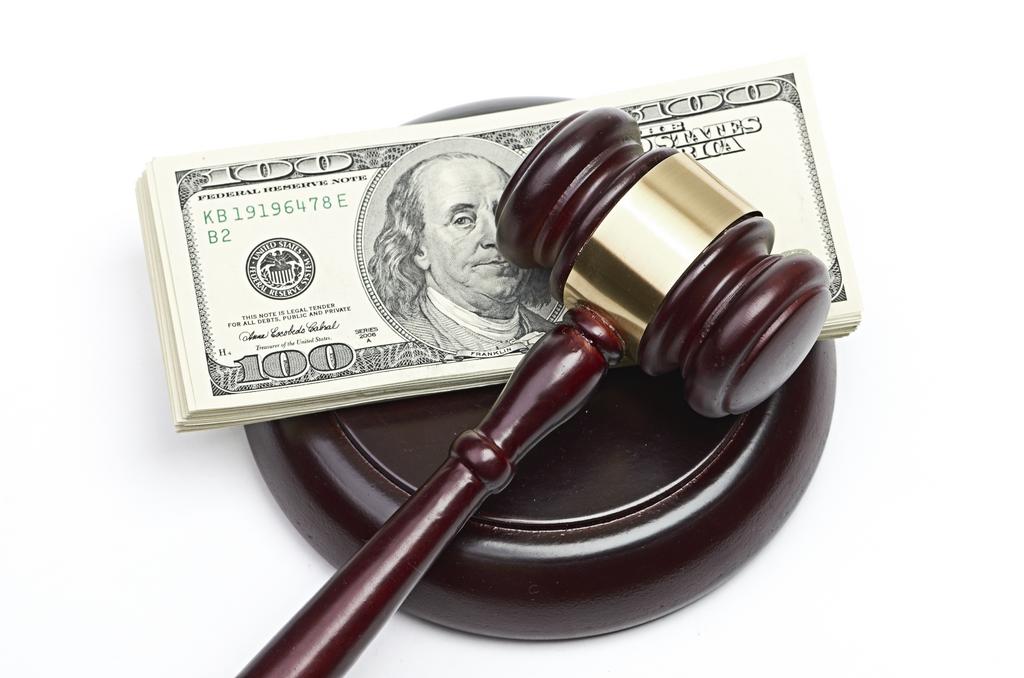Gavel resting on a stack of cash